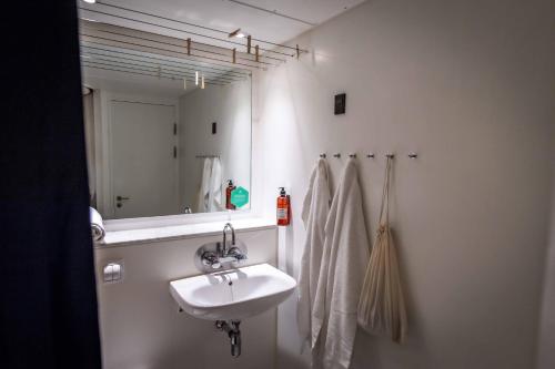 a bathroom with a sink and a mirror at Kolding Hotel Apartments in Kolding