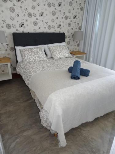 a bedroom with a bed with a blue teddy bear on it at Pool House in La Santa