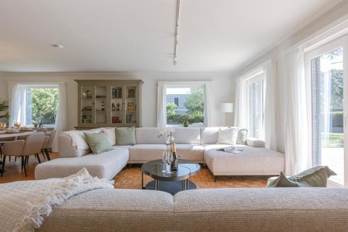 a living room with a couch and a table at Villa Camille in Sint-Idesbald