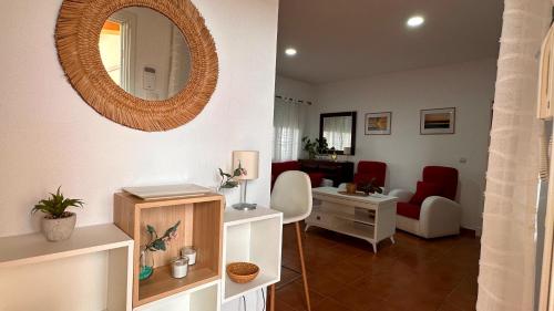 a living room with a mirror on the wall at Mika's House Valley in Sanlúcar de Barrameda