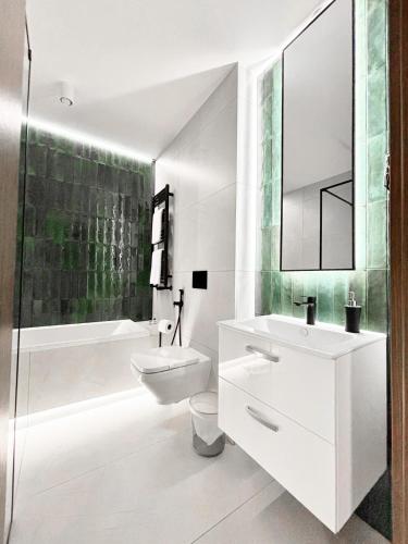 a white bathroom with a sink and a toilet at Hotel Boginia in Boginia