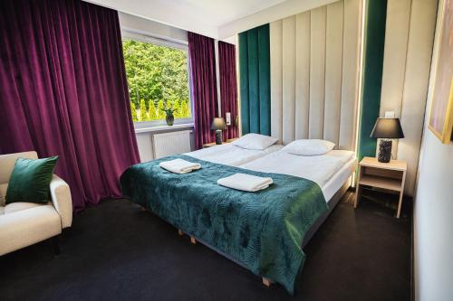 a hotel room with a bed and a window at Hotel Boginia in Boginia