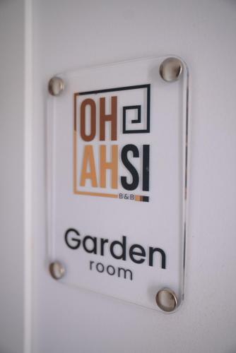 a sign on a door with the words garden room at Ohahsi in Nola
