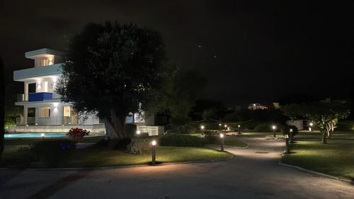 a house at night with lights in front of it at Ohahsi in Nola