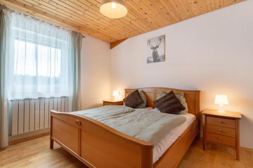 a bedroom with a bed and a large window at Fewo Naturliebe - keine Monteure in Dornhan