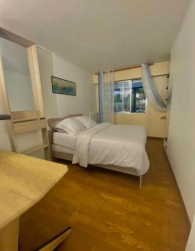 une chambre avec deux lits et une fenêtre dans l'établissement 1 min de la plage, 3 chambres, terrasse et jardin, à Nice