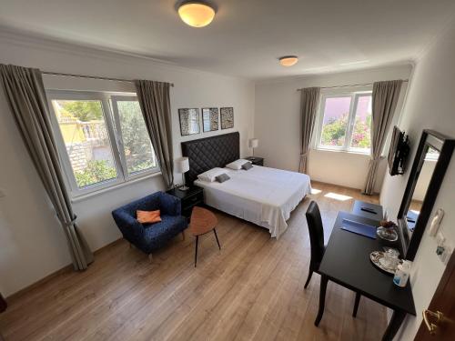a bedroom with a bed and a table and a chair at Stone House Buljanovic in Sali