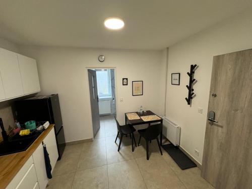 a kitchen with a table and chairs in a room at Guben Wohnungen studio in Guben