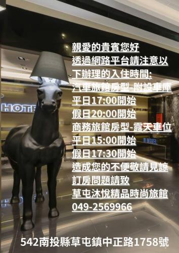 a statue of a dog with a lamp on it at M Hotel in Caotun
