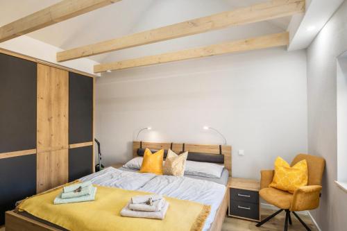 a bedroom with a bed and a chair at Ostseeoase in Boltenhagen