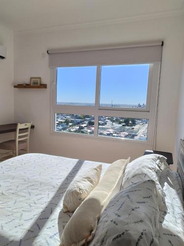 a bedroom with a bed and a large window at Espectacular depto a estrenar TANGO 15 e in Victoria