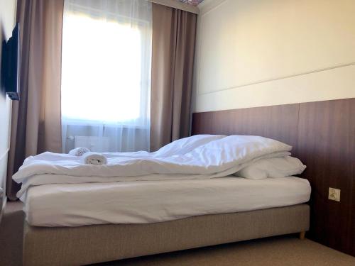 Ένα ή περισσότερα κρεβάτια σε δωμάτιο στο Sands Startowa Pokoje