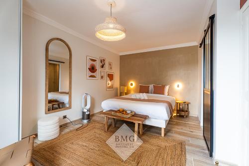 a bedroom with a king sized bed and a table at Villa Solaris Disneyland in Chalifert