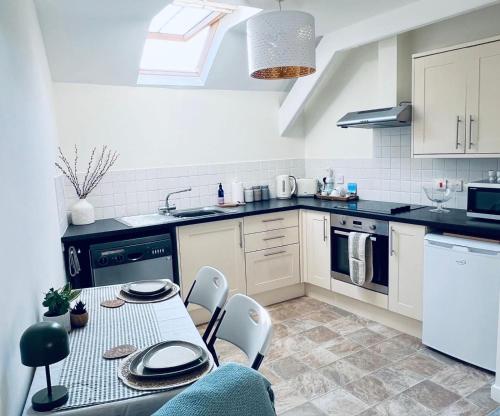 a kitchen with a table and chairs in it at Urban Stay Apartment Central Aylsham in Aylsham