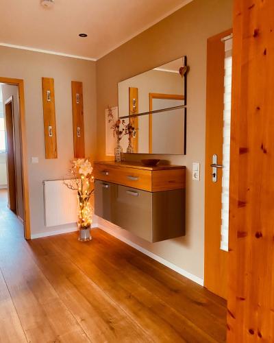 a bathroom with a sink and a mirror at Ferienwohnung "Bei Freunden" in Naumburg