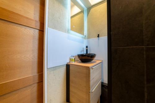 a bathroom with a sink and a window at La Galleanne studio agréable et chaleureux in Briançon