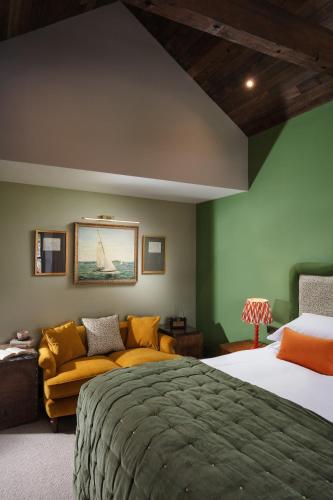 a bedroom with a bed and a couch at Pier House in St Austell