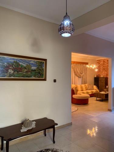 a living room with a couch and a table at House maria elenι in Skala Kallirachis