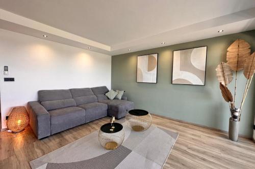 un salon avec un canapé et une table dans l'établissement Le Mistral Appartement Standing avec Vue Mer Exceptionnelle en 1ère Ligne, au Grau-du-Roi
