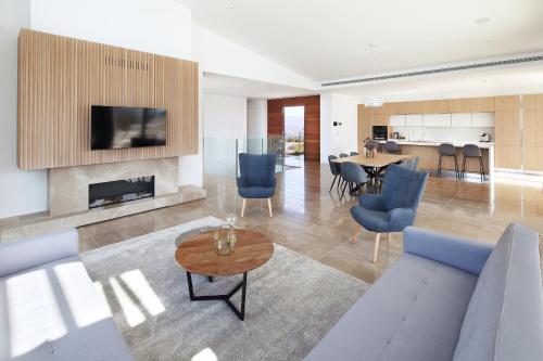 a living room with a couch and a table at Minthis Resort in Paphos City
