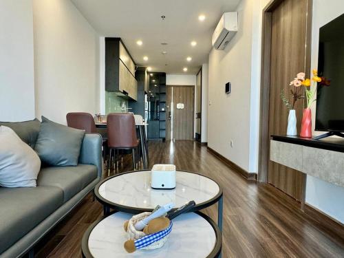 a living room with a couch and a table at LeeVy Hai Phong in Hai Phong