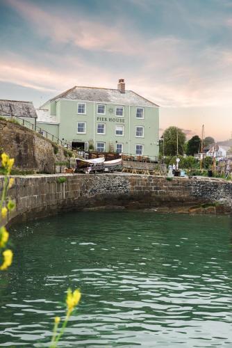 a large building next to a body of water at Pier House in St Austell