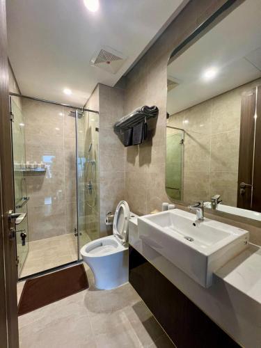 a bathroom with a sink and a toilet and a shower at LeeVy Hai Phong in Hai Phong
