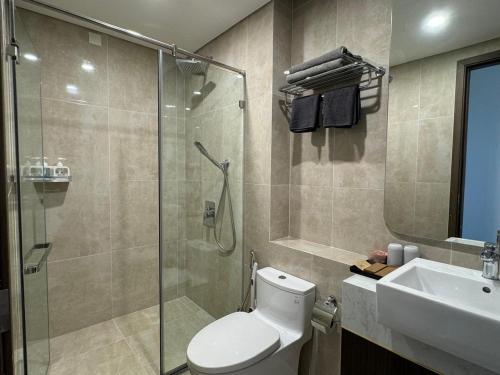a bathroom with a shower and a toilet and a sink at LeeVy Hai Phong in Hai Phong