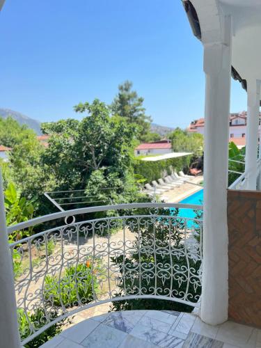 a balcony with a view of a swimming pool at Central Park Otel - Adult Only in Dalyan