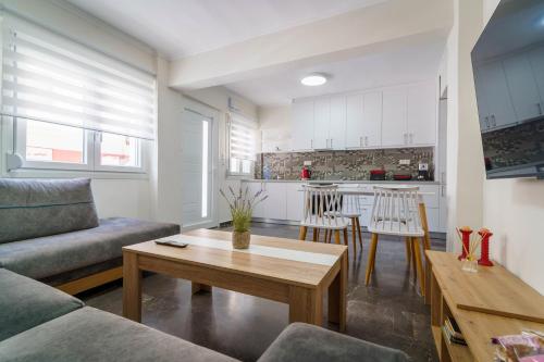 a living room with a couch and a table at Luxury apartment in Chios 1 in Chios