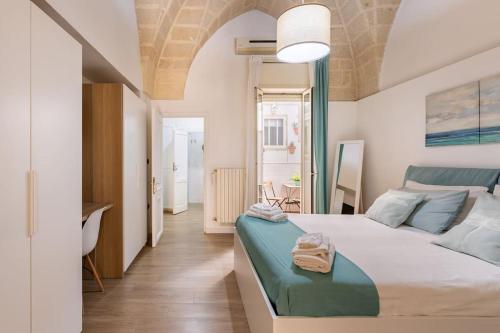 a bedroom with a bed and a desk in it at Al Duomo in Brindisi