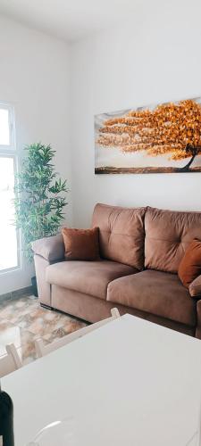 a living room with a couch and a painting on the wall at Casa Agustina in Arguineguín