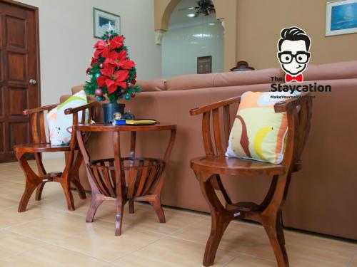 a living room with two chairs and a couch at Staycation Homestay 50 Peaceful Villa Damai in Kuching