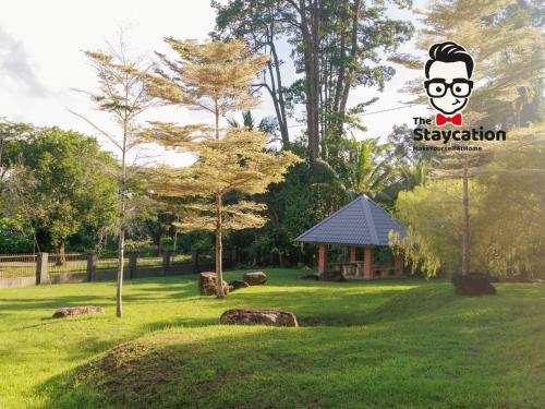 a park with a sign that says the staycation at Staycation Homestay 50 Peaceful Villa Damai in Kuching