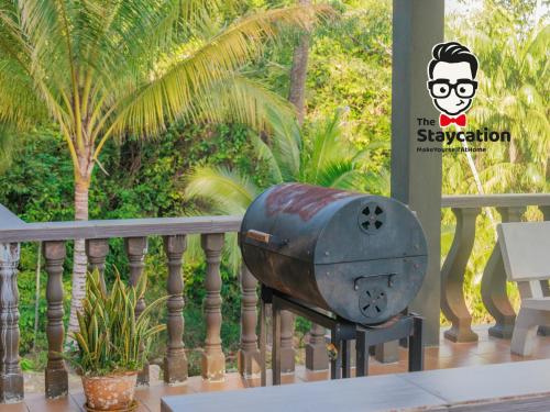a metal trash can sitting on the side of a balcony at Staycation Homestay 50 Peaceful Villa Damai in Kuching