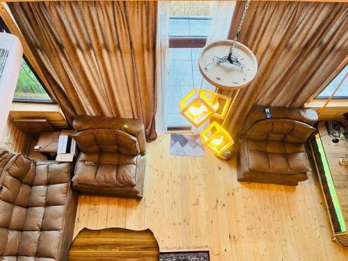 an overhead view of a living room with leather furniture at Mountain Star in Batumi