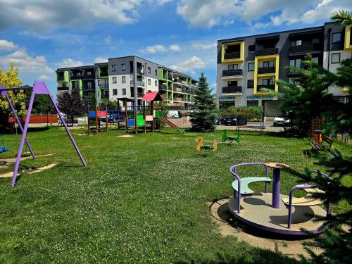 a park with playground equipment in the grass at Venus in Zamość