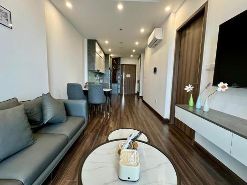 a living room with a couch and a table at LeeVy Hai Phong in Hai Phong
