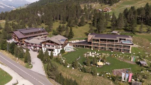 an aerial view of a large building on a mountain at Hotel Gran Paradiso in San Cassiano