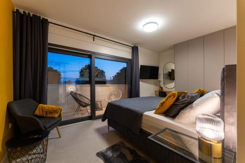 a bedroom with a bed and a window with a balcony at D Marine villa in Bibinje