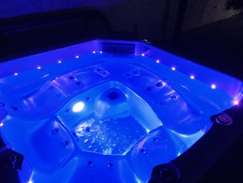 a blue tub filled with water in a dark room at Villa S in Vir