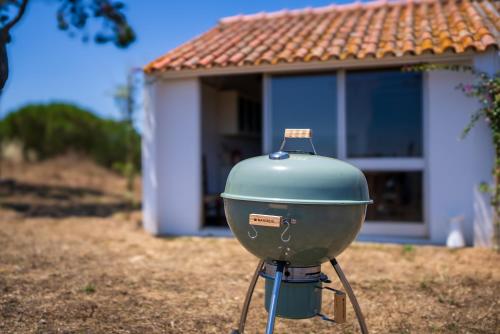 a blue boiler sitting in front of a house at A Casinha in São Bartolomeu da Serra