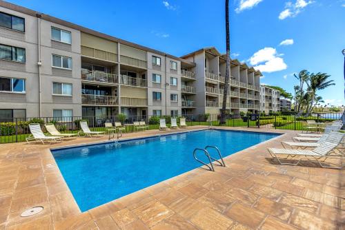 a swimming pool in front of a apartment building at Maalaea Kai 220 in Wailuku