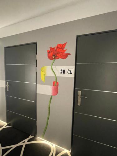 a wall with a flower painted on it at Canpol-Jull's Art Hotel in Człuchów