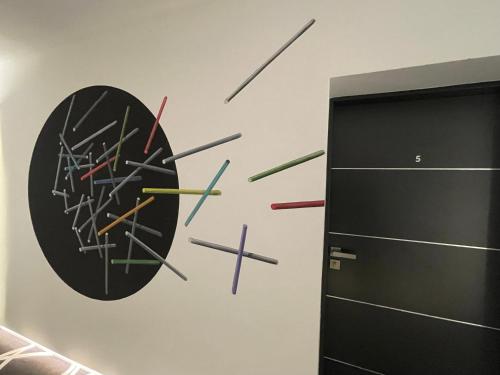 a clock with arrows on a wall in a room at Canpol-Jull's Art Hotel in Człuchów