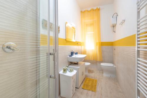 a bathroom with a sink and a toilet at Piombino Apartments Casa Collodi II in Piombino