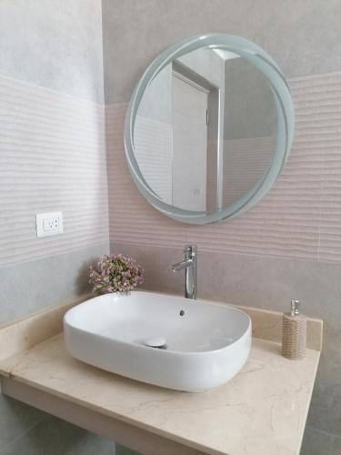 a bathroom with a white sink and a mirror at Star of Caribbean- Estrella Dominicus Bayahibe in Bayahibe