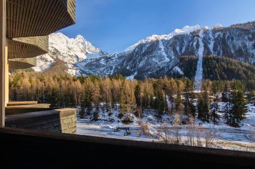 a view of a snow covered mountain from a window at Résidence Grand Roc - Campanules 314 Happy Rentals in Chamonix-Mont-Blanc