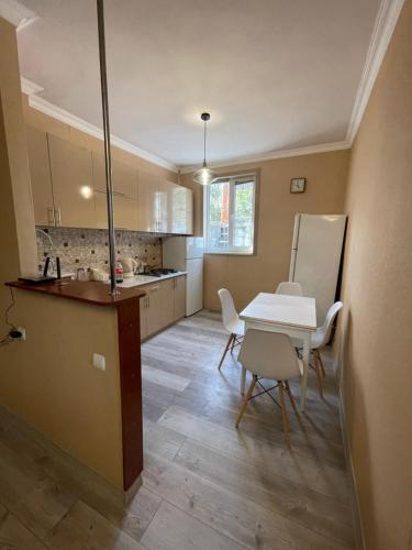 a kitchen with a table and a white table and chairs at Bjni Mer Dacha in Bjni