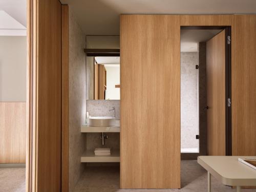 a bathroom with a sink and a mirror at City Hotel Thessaloniki in Thessaloniki